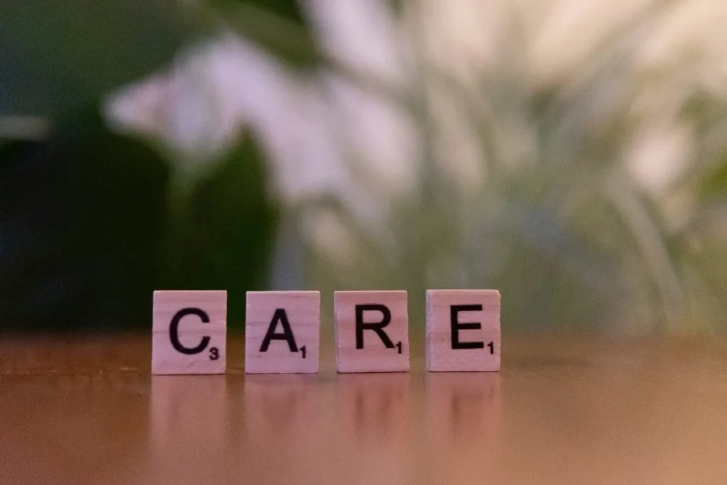 Wooden blocks spelling CARE on a table